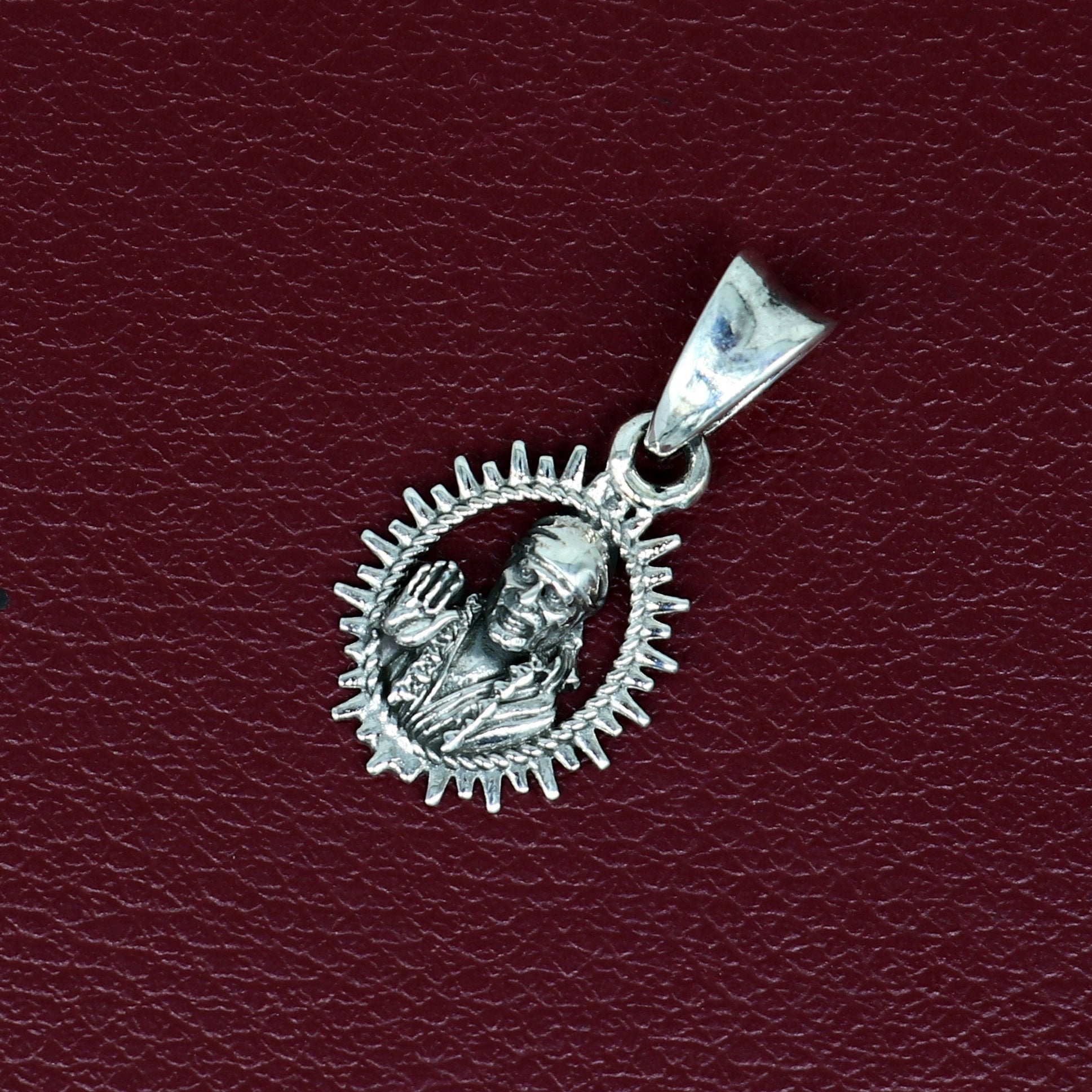 Sterling silver Sai Baba pendant by TRIBAL ORNAMENTS, handmade Indian religious jewelry, stylish unisex locket.