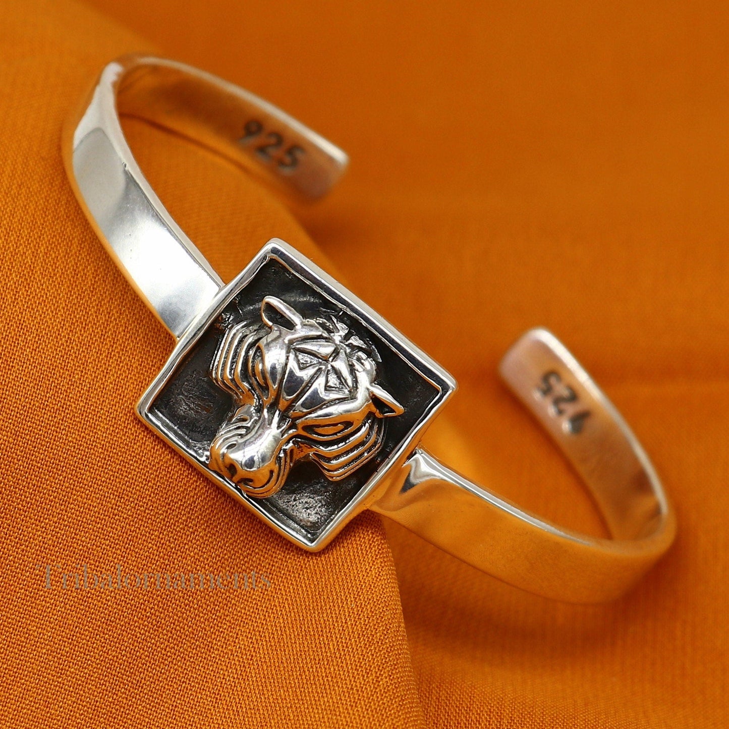 Sterling silver lion face design adjustable bangle cuff bracelet by TRIBAL ORNAMENTS, unisex ethnic jewelry with intricate details.