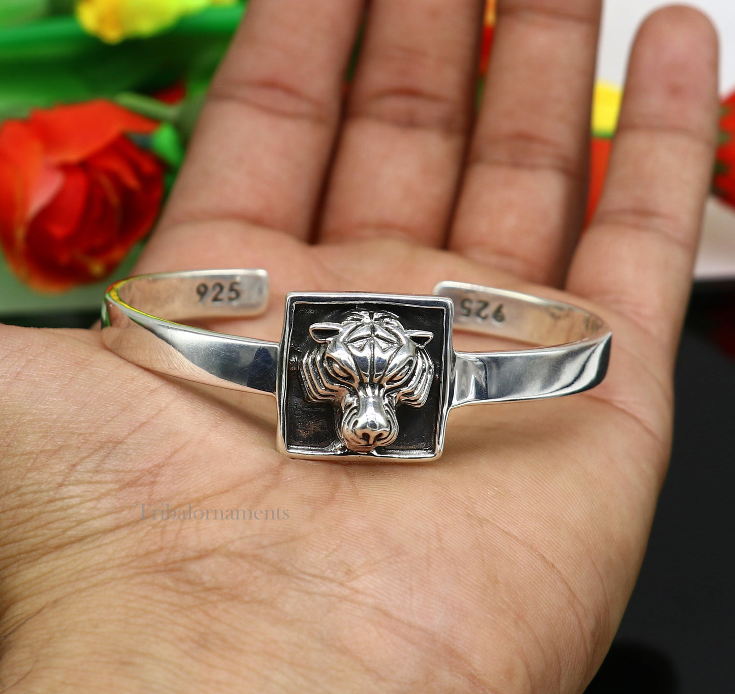 Sterling silver lion face design adjustable bangle bracelet by Tribal Ornaments, unisex ethnic jewelry with intricate handcrafted details.