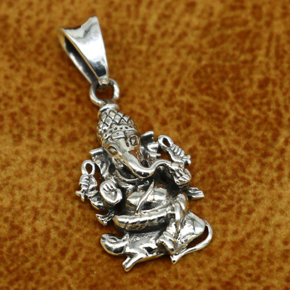 Sterling silver Lord Ganesha pendant by TRIBAL ORNAMENTS, handmade unisex jewelry with a detailed cross design.