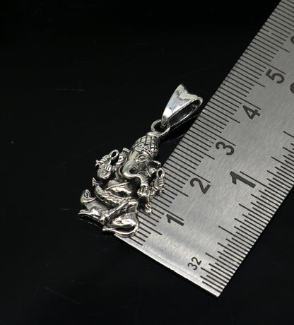 Sterling silver Lord Ganesha pendant by TRIBAL ORNAMENTS, unisex handmade jewelry with cross design, perfect for gifting.