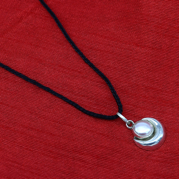 Sterling silver moon pendant with natural pearl by Tribal Ornaments, unisex jewelry featuring handcrafted design and elegant moon motif.