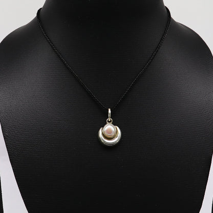 Sterling silver moon pendant with natural pearl, unisex jewelry by TRIBAL ORNAMENTS, featuring handcrafted design and elegant details.