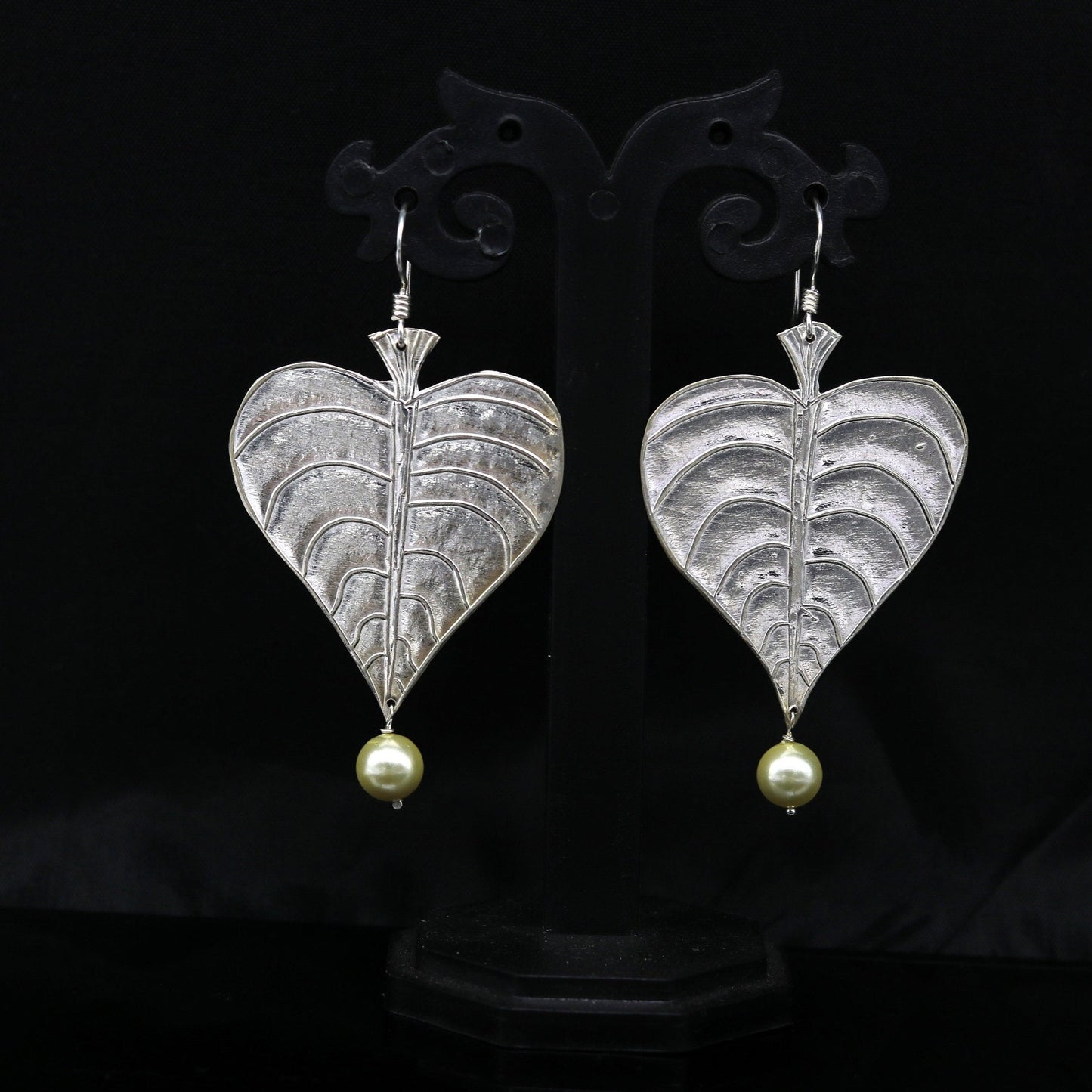 Sterling silver handmade peepal tree leaf earring with hanging pearl from Tribal Ornaments, featuring customized hoop design.