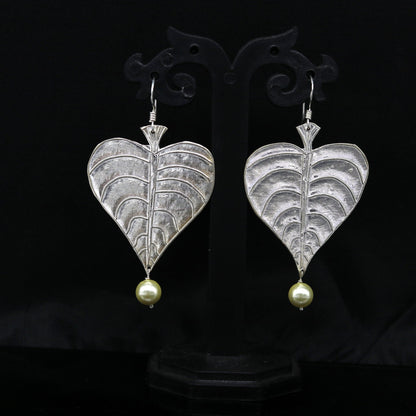 Sterling silver handmade peepal tree leaf earring with hanging pearl from Tribal Ornaments, featuring customized hoop design.