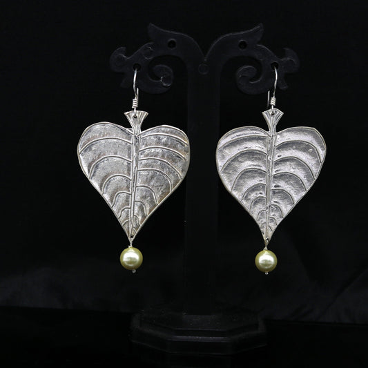 Sterling silver handmade peepal tree leaf earring with hanging pearl from Tribal Ornaments, featuring customized hoop design.