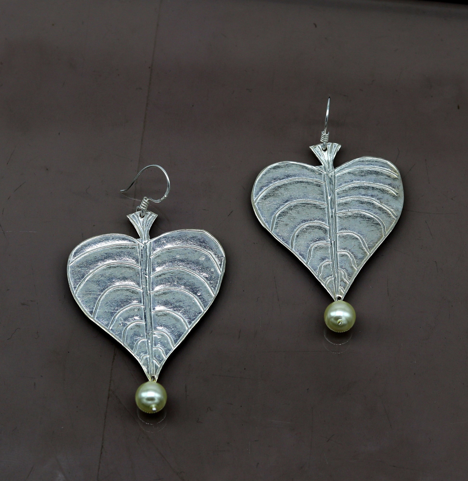 Sterling silver handmade peepal tree leaf earring with hanging pearl, custom hoop design from Tribal Ornaments summer collection.