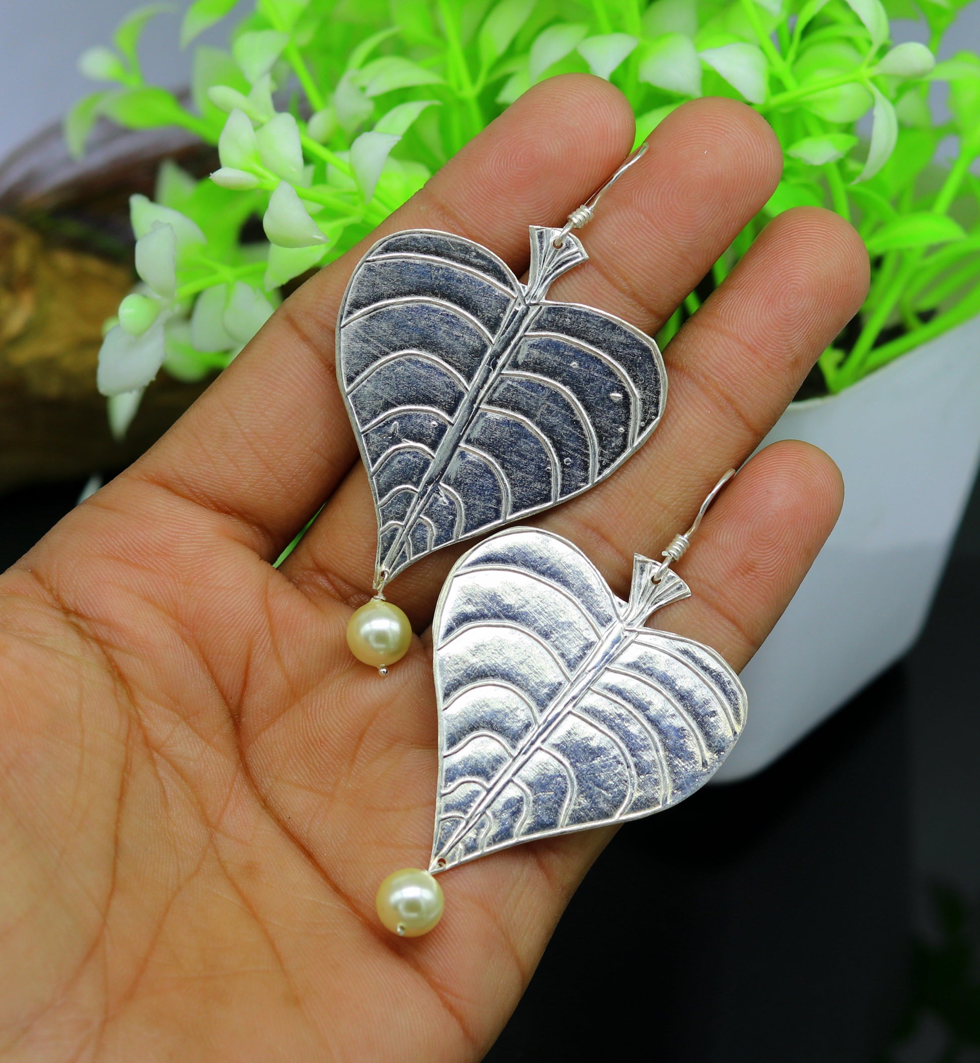 Sterling silver handmade peepal tree leaf earring with hanging pearl and hoop design, part of TRIBAL ORNAMENTS summer collection.