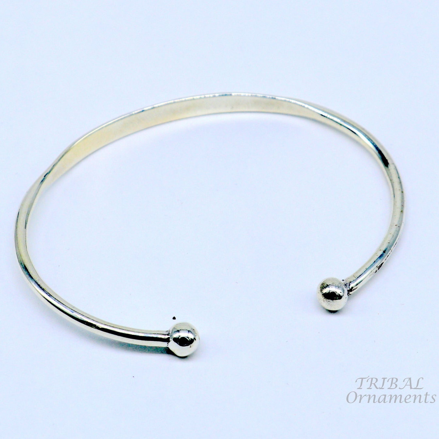 Shiny 925 sterling silver handmade bangle bracelet with a plain design, stylish cuff style, ideal for gifting by TRIBAL ORNAMENTS.