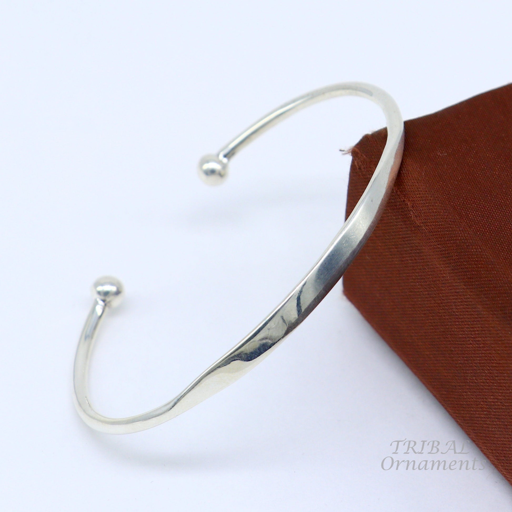 Sterling silver handmade bangle bracelet with a shiny plain design, stylish cuff style perfect for gifting or everyday wear.