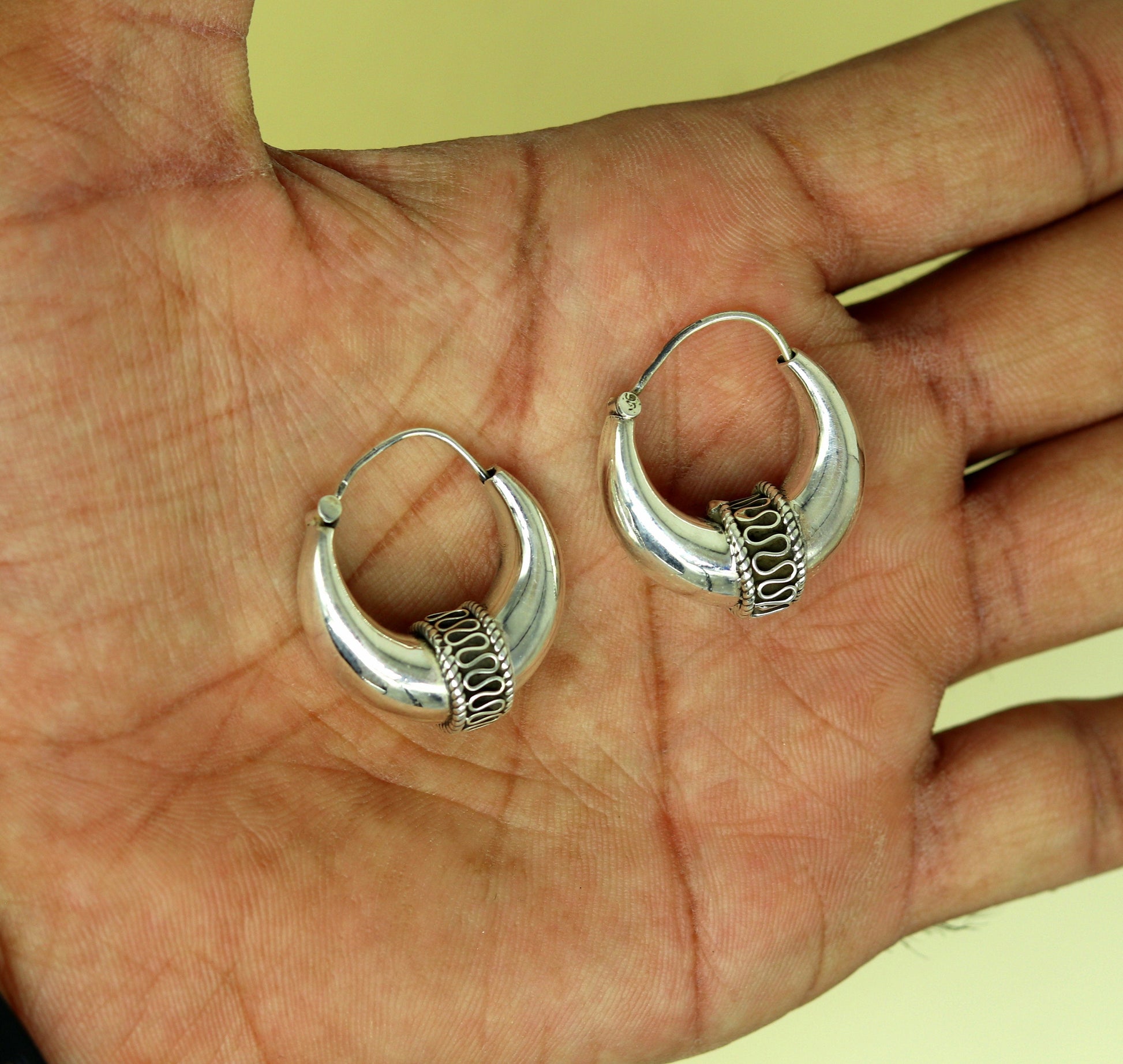 Sterling silver handmade hoop earrings by TRIBAL ORNAMENTS, stylish and attractive Bali-style stud earrings, perfect for personalized gifts.