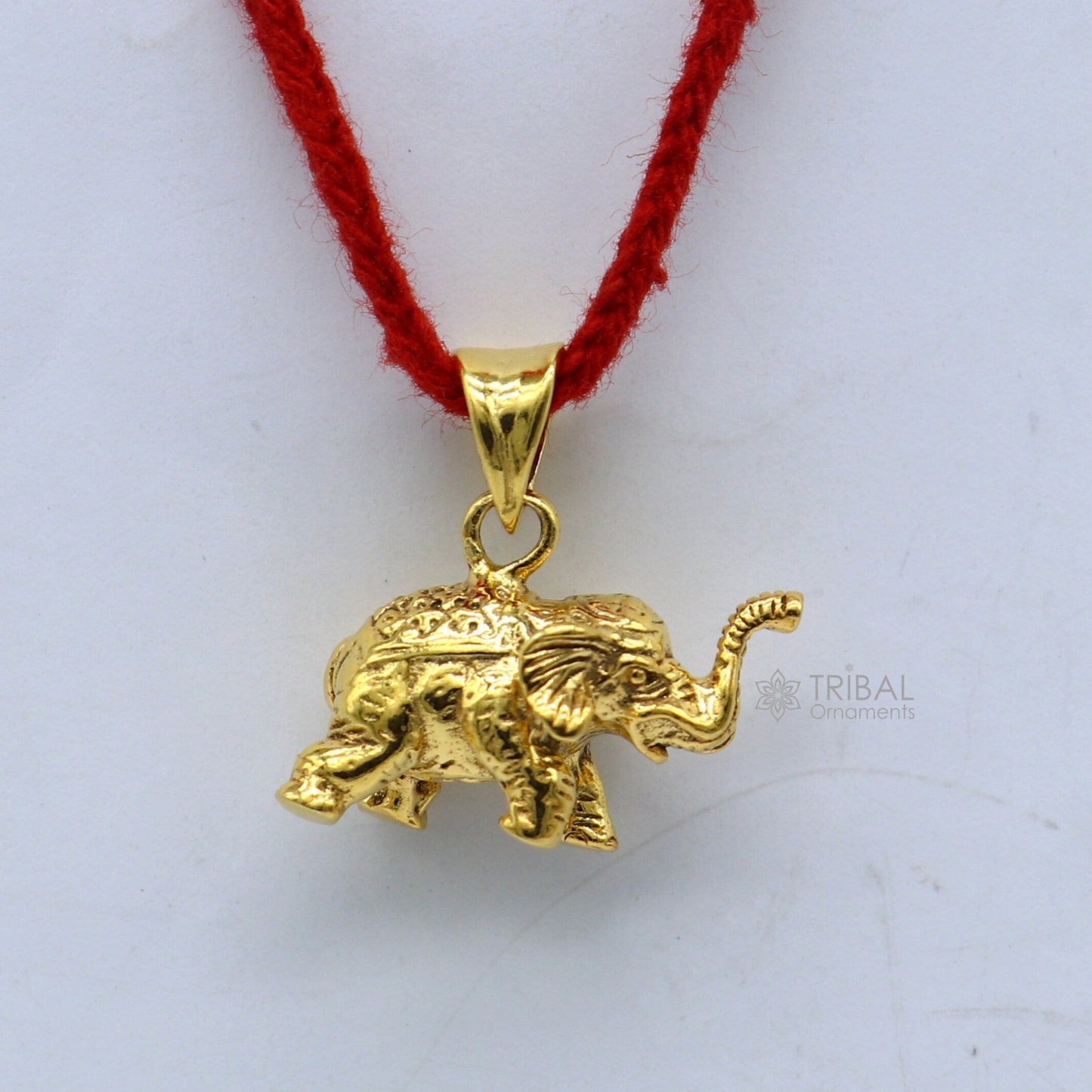 925 sterling silver elephant pendant with gold polish, handmade tribal jewelry, featuring a small, detailed lucky elephant design.