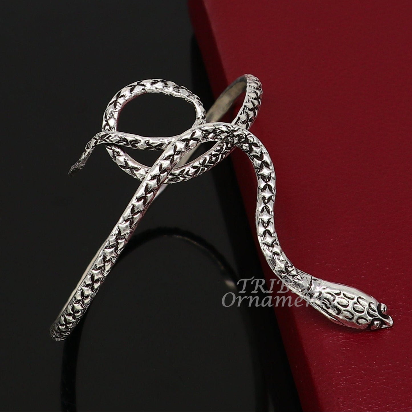 Sterling silver snake design bangle cuff bracelet by TRIBAL ORNAMENTS, featuring a detailed cobra motif in a unisex jewelry style.