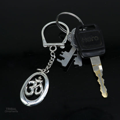 Sterling silver OM Aum mantra key chain by TRIBAL ORNAMENTS, featuring a solid design and intricate details, unisex stylish accessory.