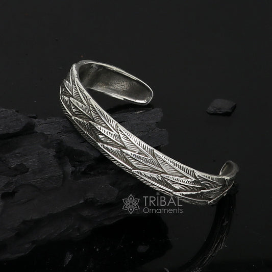 Sterling silver wing feather design adjustable bangle cuff bracelet by TRIBAL ORNAMENTS, unisex jewelry with intricate feather details.