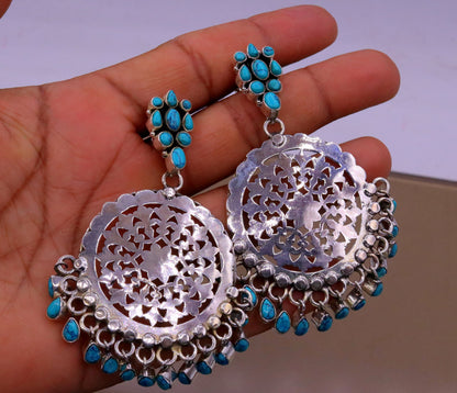 Sterling silver vintage-style tribal earrings with turquoise stone drops, handcrafted large stud design from India.