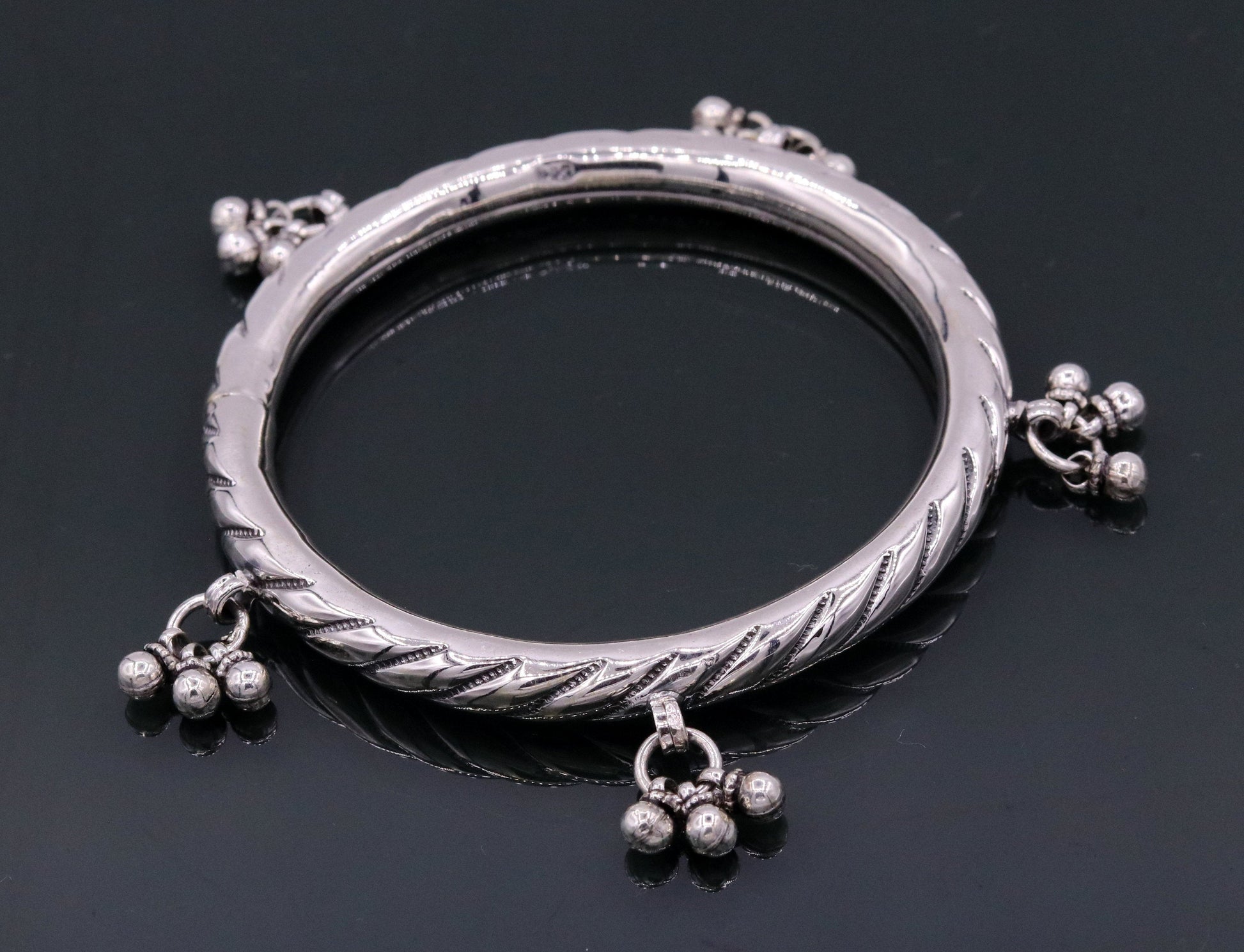 Sterling silver vintage design charm bangle bracelet featuring tribal-inspired details, handmade by TRIBAL ORNAMENTS for wedding jewelry.