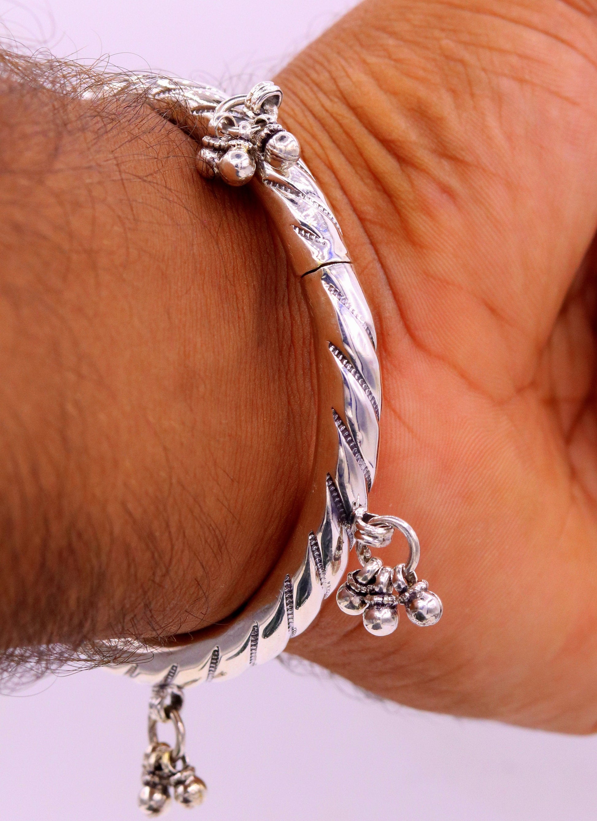Vintage 925 sterling silver charm bangle bracelet with tribal design, handcrafted jewelry perfect for weddings and special occasions.
