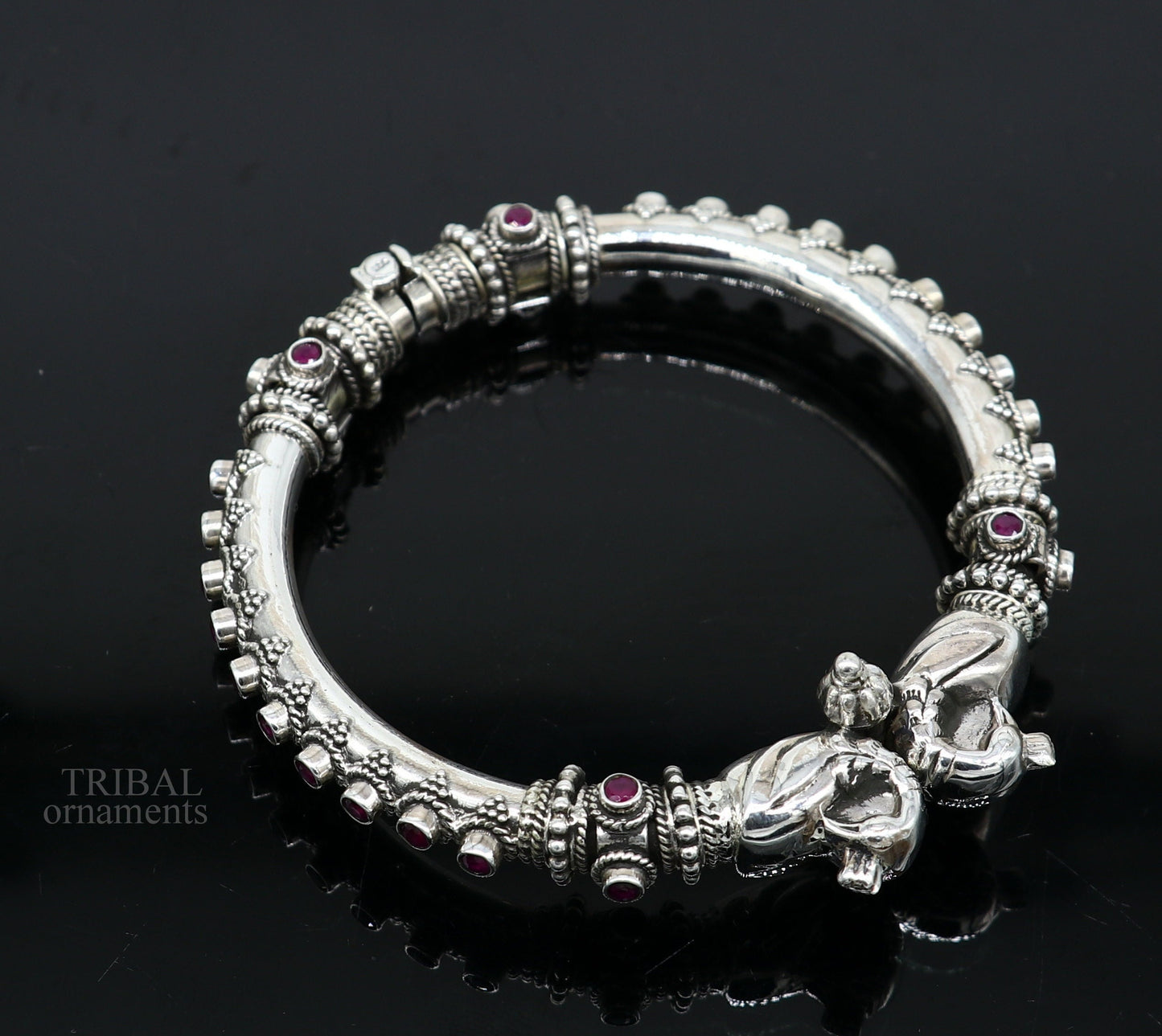 Sterling silver tribal belly dance bangle bracelet with vintage peacock design and garnet stone accents from TRIBAL ORNAMENTS.
