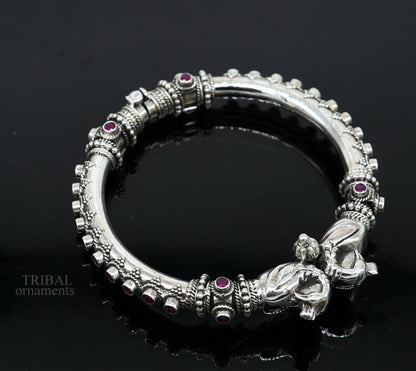 Sterling silver tribal belly dance bangle bracelet with vintage peacock design and garnet stone accents from TRIBAL ORNAMENTS.