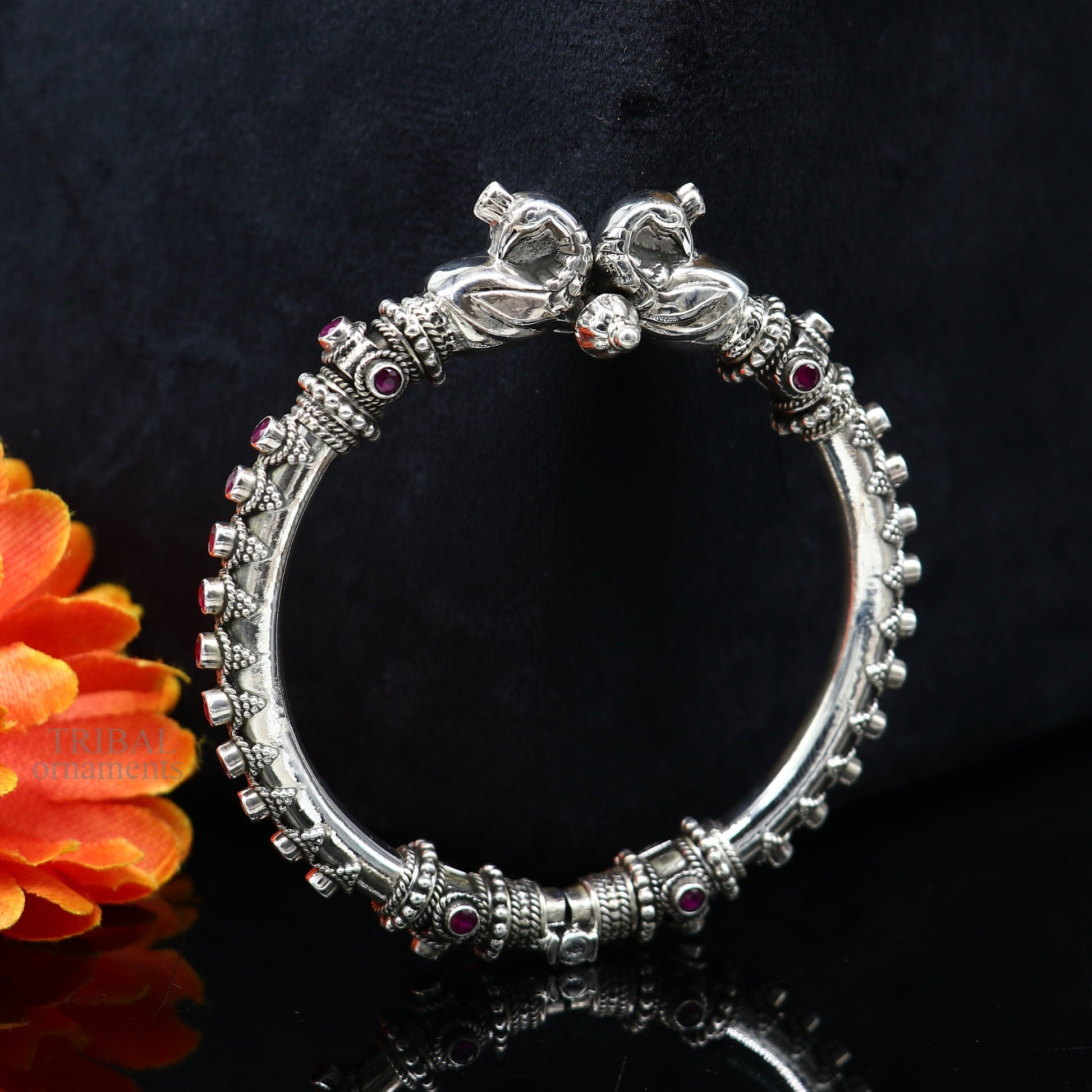 Sterling silver tribal belly dance bangle bracelet with vintage peacock design and garnet stones, handcrafted ethnic jewelry.