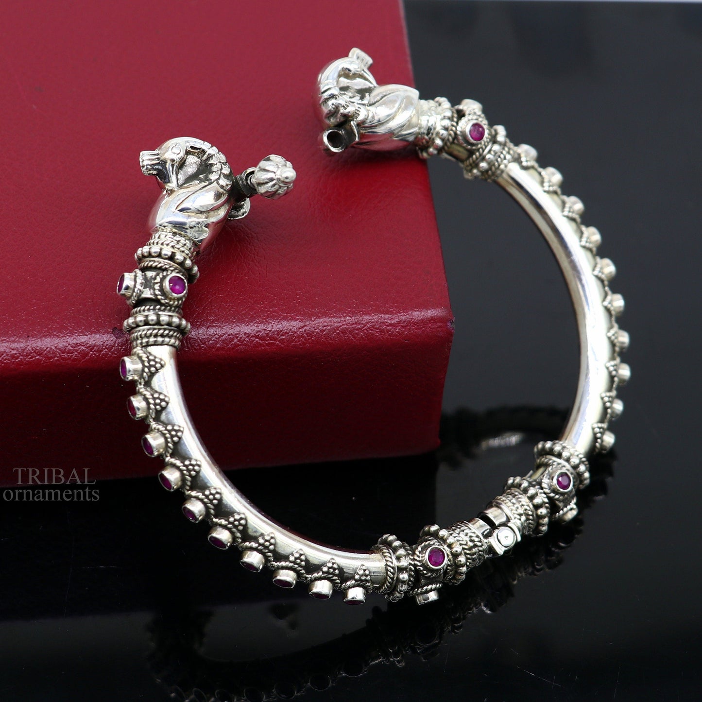 Sterling silver tribal belly dance bangle bracelet with vintage peacock design and garnet stones, handcrafted by Tribal Ornaments.