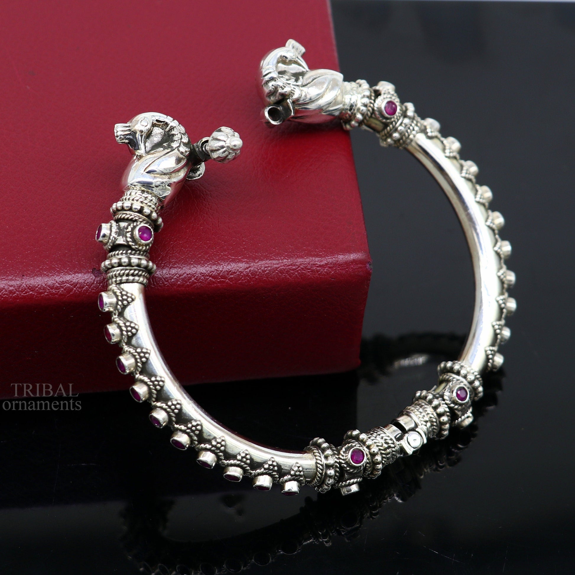 Sterling silver tribal belly dance bangle bracelet with vintage peacock design and garnet stones, handcrafted by Tribal Ornaments.