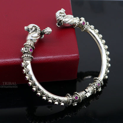 Sterling silver tribal belly dance bangle bracelet with vintage peacock design and garnet stones, handcrafted by Tribal Ornaments.