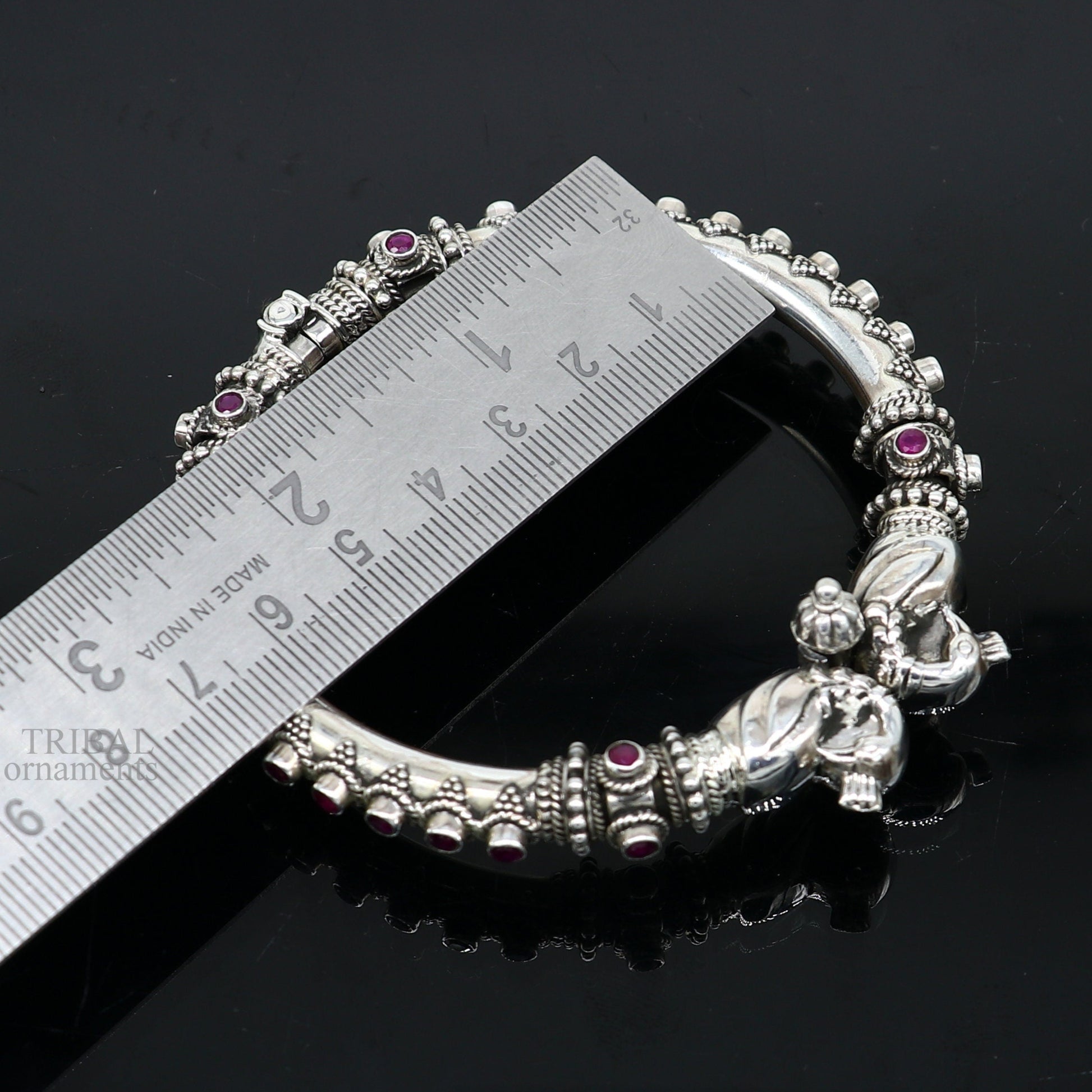 Sterling silver tribal bangle bracelet with vintage peacock design and garnet stones, perfect for belly dance or ethnic gifting.