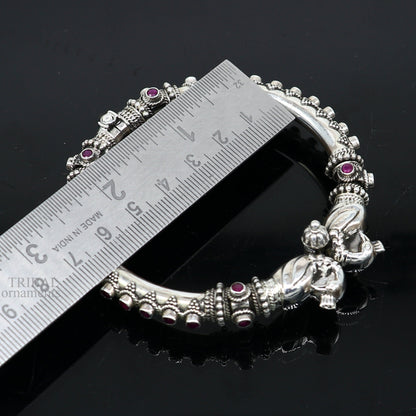 Sterling silver tribal bangle bracelet with vintage peacock design and garnet stones, perfect for belly dance or ethnic gifting.