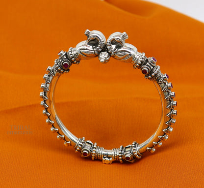 Sterling silver tribal belly dance bangle with vintage peacock design and garnet stone accents, handcrafted ethnic jewelry by Tribal Ornaments.