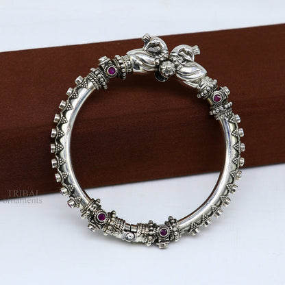 Sterling silver tribal belly dance bangle bracelet with vintage peacock design and garnet stone accents by TRIBAL ORNAMENTS.
