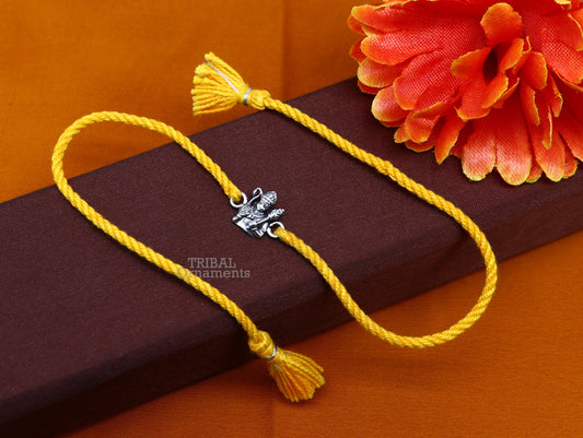 Sterling silver Lord Hanuman bracelet thread rakhi by TRIBAL ORNAMENTS, featuring intricate Hindu deity design on silver band