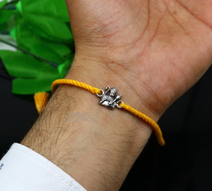 925 Sterling silver Lord Hanuman bracelet thread rakhi by TRIBAL ORNAMENTS featuring intricate Hindu deity design on a silver bracelet.