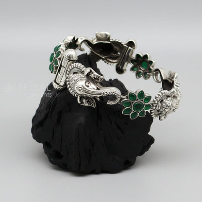 Sterling silver Ganesha bangle bracelet with floral design and green stone from TRIBAL ORNAMENTS, ethnic jewelry.