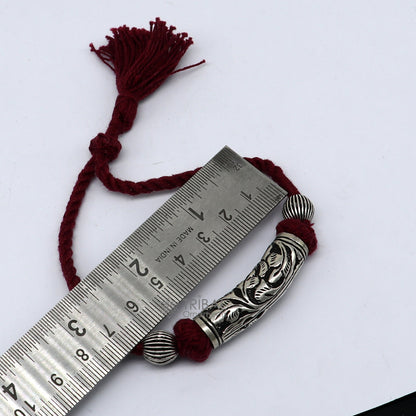 Sterling silver modern charm bracelet with intricate tribal design, adjustable fit, ideal for brides and ethnic jewelry styling.