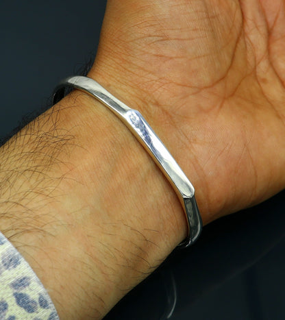Sterling silver bangle cuff bracelet with shiny finish, adjustable unisex design, ideal for personalized gifting.