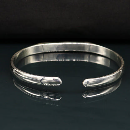 Sterling silver bangle bracelet from Tribal Ornaments, shiny and adjustable unisex cuff with personalized gifting appeal.