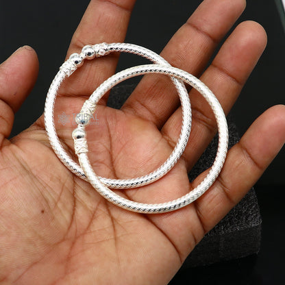Sterling silver bangle bracelet by Tribal Ornaments, shiny and bright, stylish unisex jewelry perfect for personalized gifting.