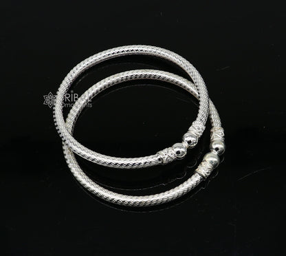 Sterling silver bangle bracelet by Tribal Ornaments, shiny and bright, stylish unisex jewelry perfect for personalized gifting.