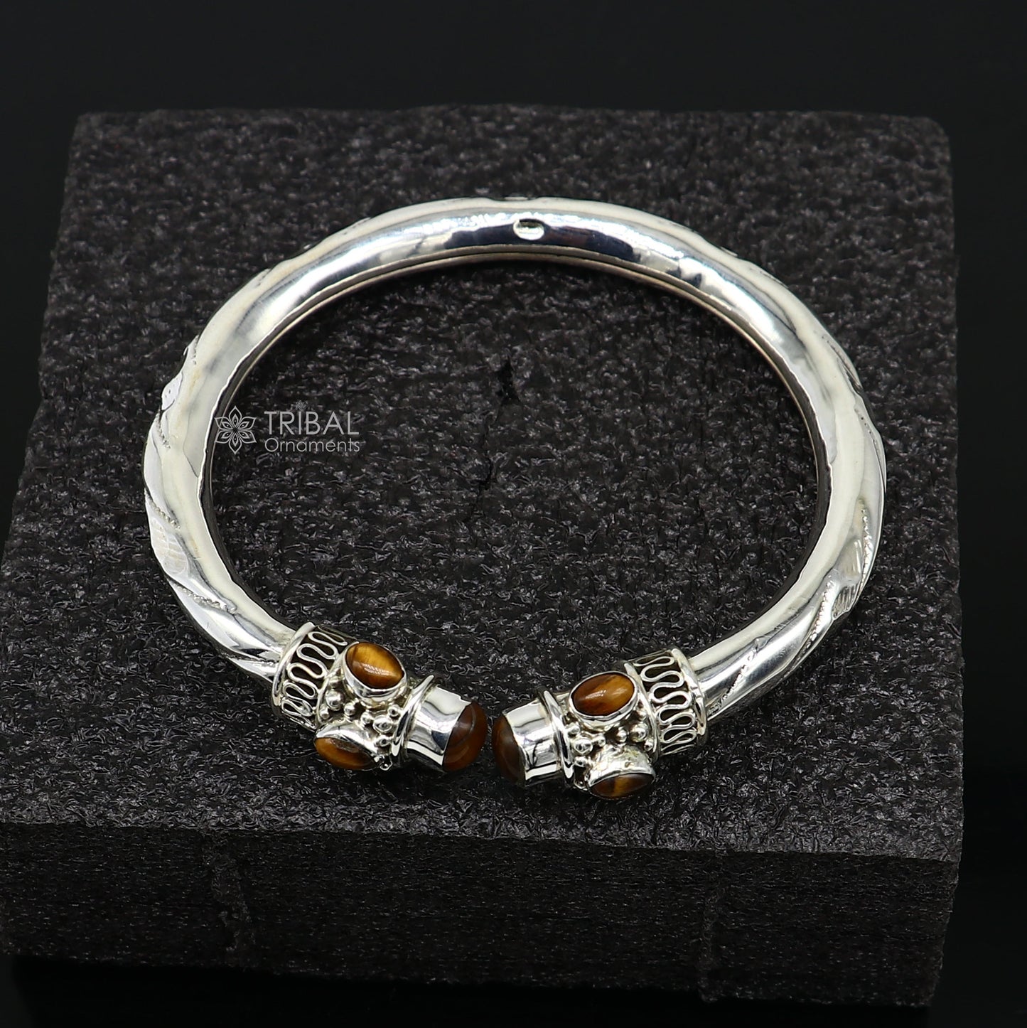 Unisex 925 sterling silver bangle bracelet with tiger eye stones, featuring a customized tribal design.