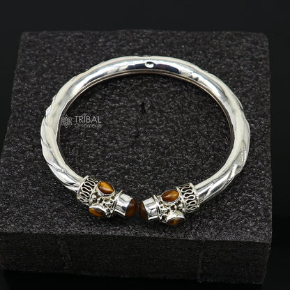 Unisex 925 sterling silver bangle bracelet with tiger eye stones, featuring a customized tribal design.