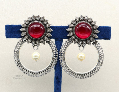 Handmade 925 sterling silver tribal earrings with glossy red stone studs, featuring traditional ethnic design.