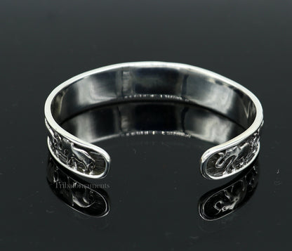 Sterling silver handcrafted elephant design cuff bangle bracelet by TRIBAL ORNAMENTS, adjustable unisex tribal jewelry accessory.
