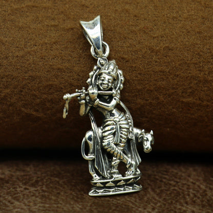 Sterling silver Krishna with cow pendant jewelry by TRIBAL ORNAMENTS, vintage Hindu idol design, perfect for gifting.