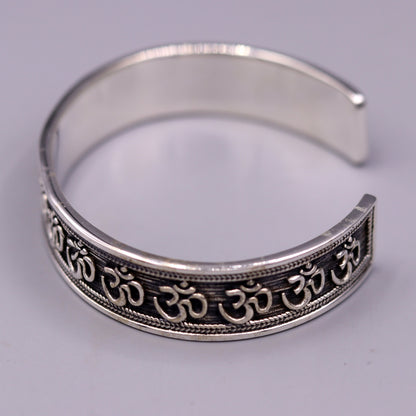 Sterling silver 'AUM' mantra cuff bracelet by TRIBAL ORNAMENTS, handcrafted unisex jewelry with adjustable design and ethnic style.