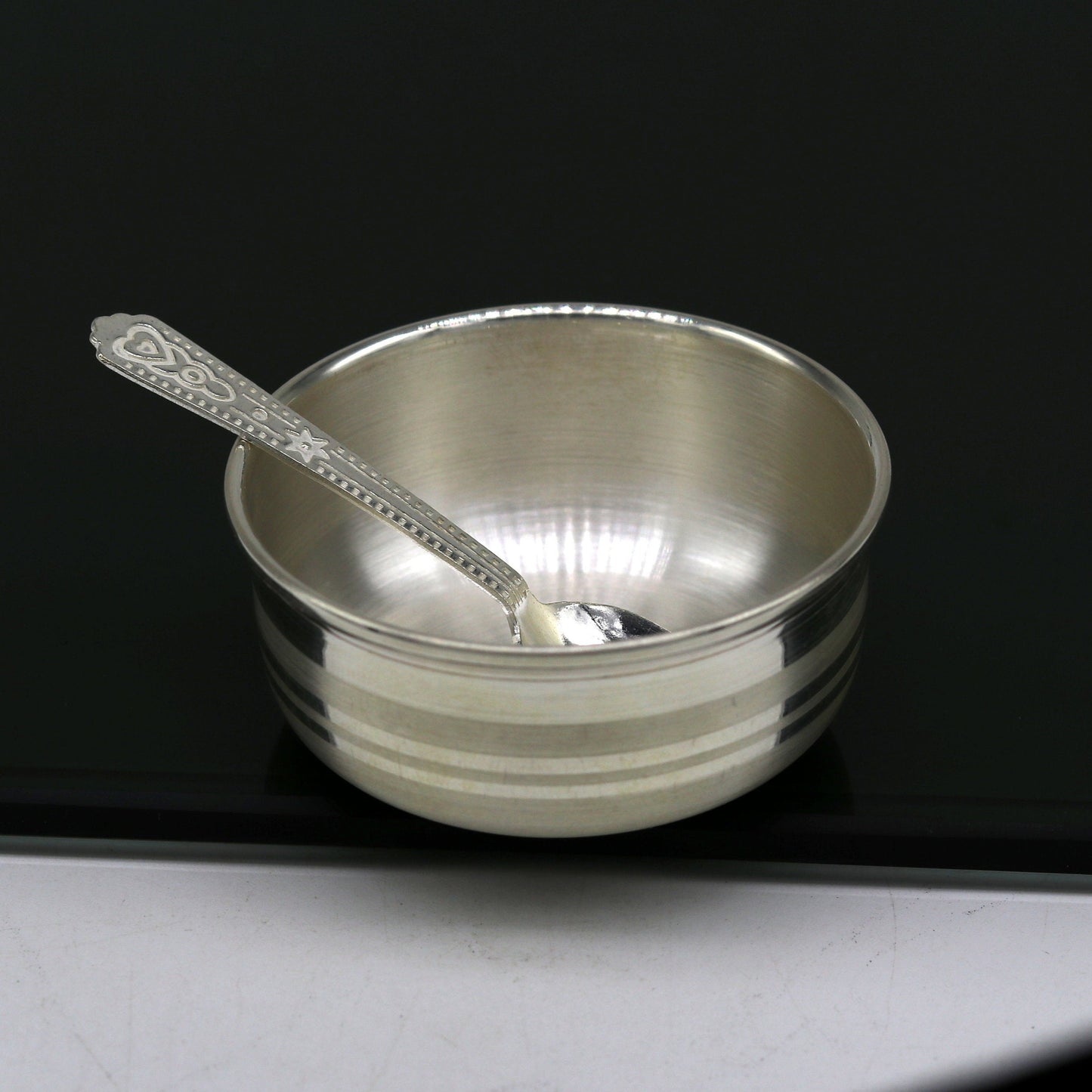 Handmade 999 fine silver bowl and spoon set by TRIBAL ORNAMENTS, featuring antibacterial silver for kids' health and safety.