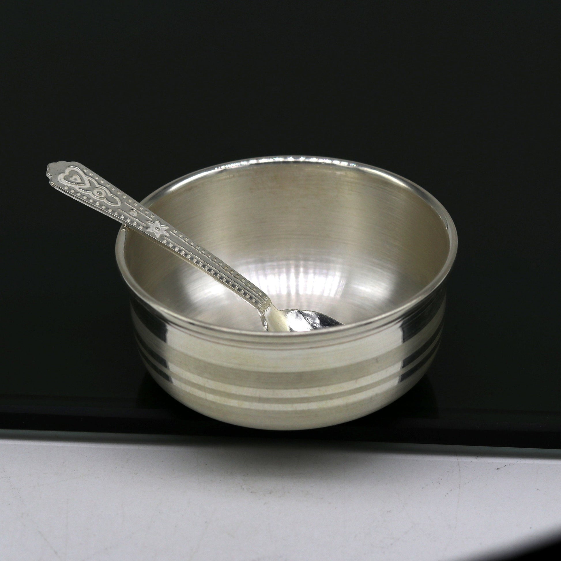 Handmade 999 fine silver bowl and spoon set by TRIBAL ORNAMENTS, featuring antibacterial silver for kids' health and safety.