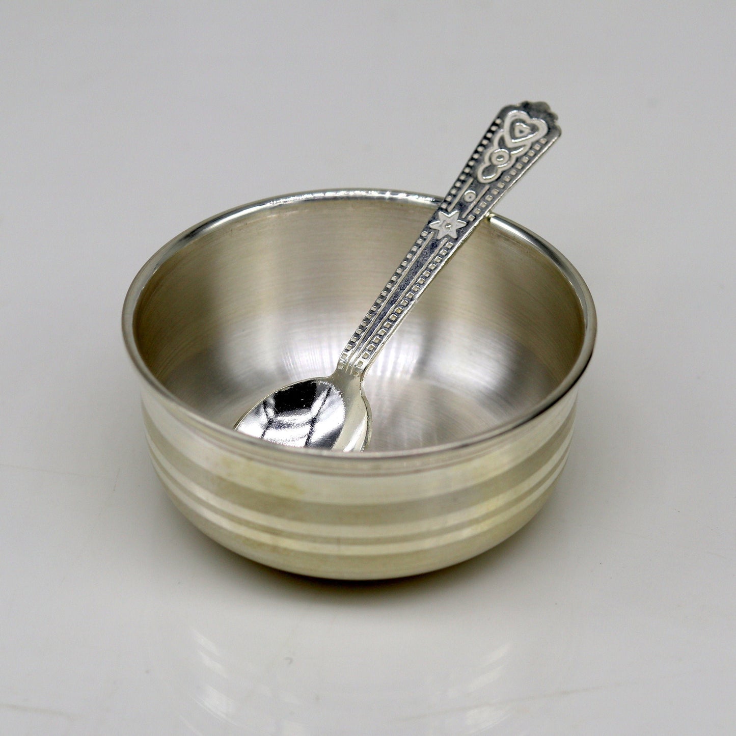 Handmade 999 fine silver bowl and spoon set by TRIBAL ORNAMENTS, featuring antibacterial properties for healthy kids and babies.