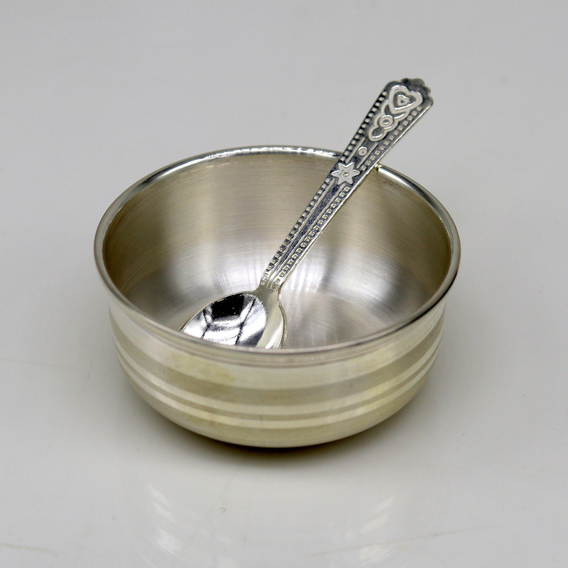 Handmade 999 fine silver bowl and spoon set by TRIBAL ORNAMENTS, featuring antibacterial properties for healthy kids and babies.